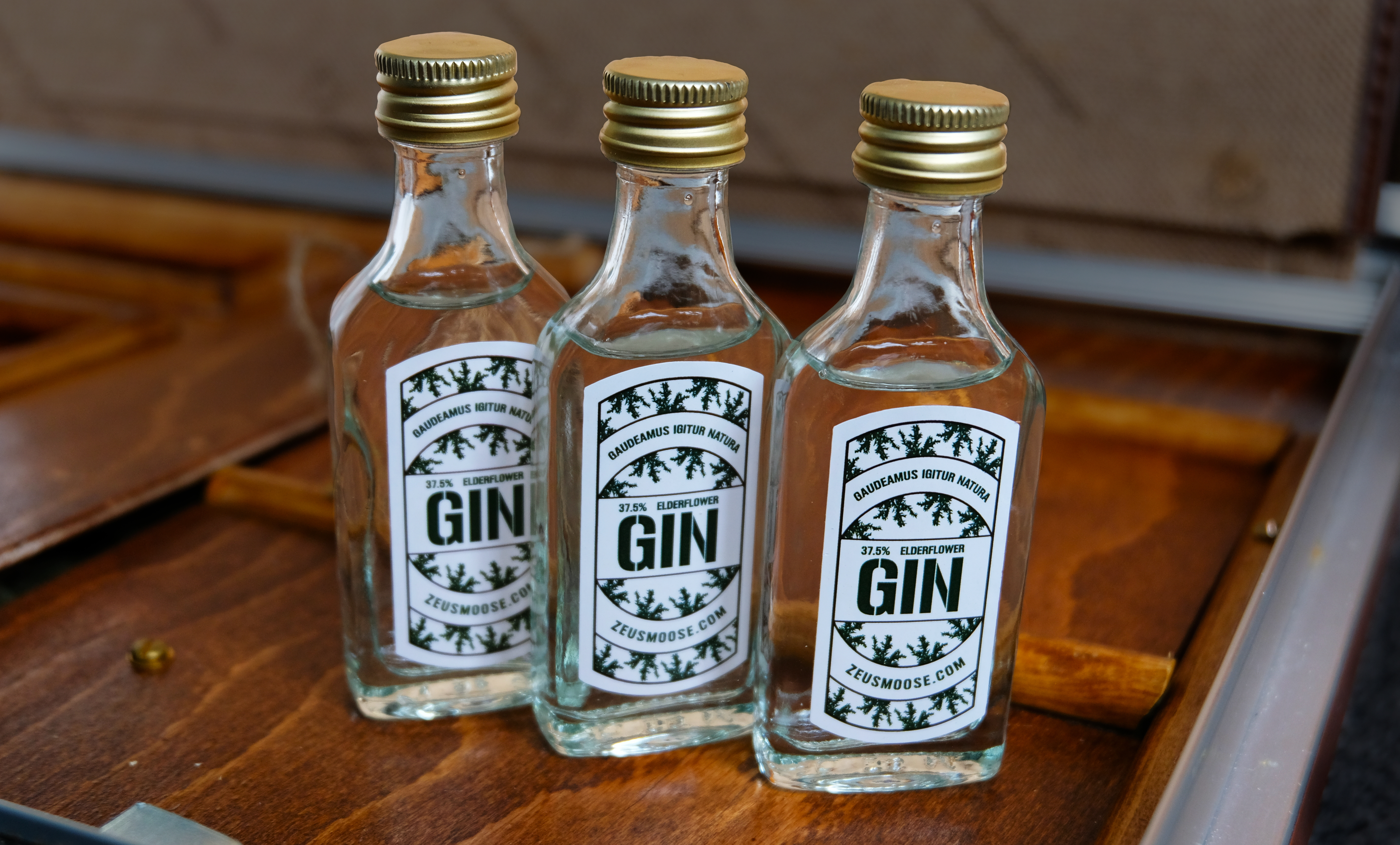 Three very cute little bottles of gin stand proud